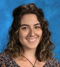 A photo of Farrah Emami with a blue background